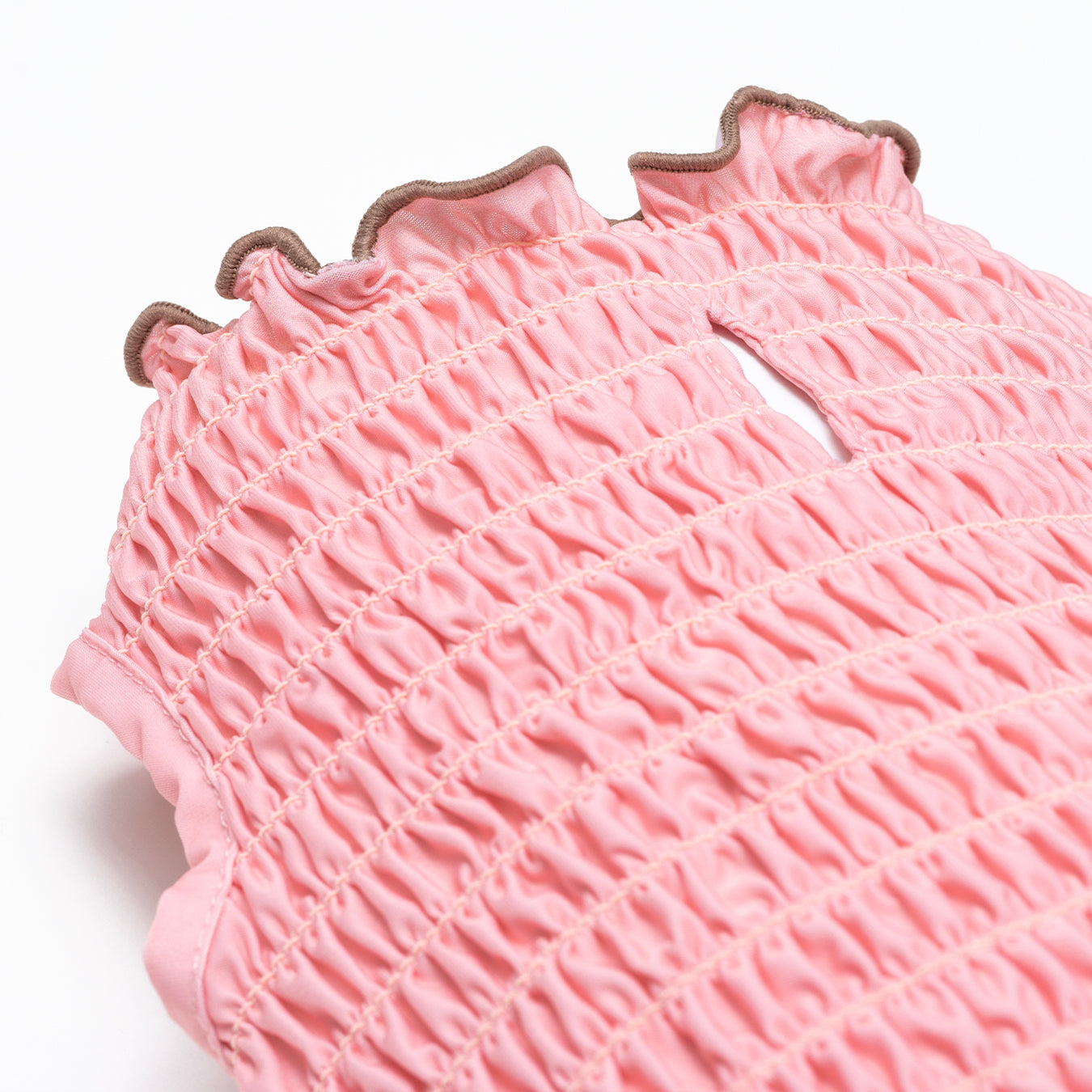 Salmon pink tank top made with a cool-to-touch silky fabric and smocked detail. 